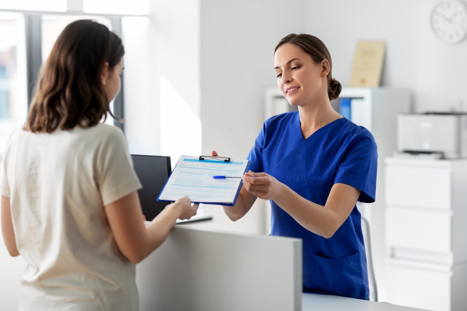 nurse checking in a female patient